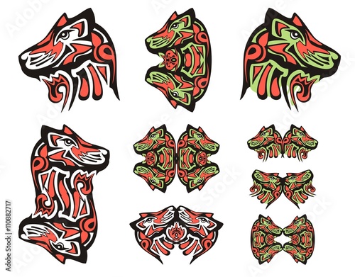 Haida wolf head tattoos. Tribal double symbols of the wolf head executed in black, red and green color