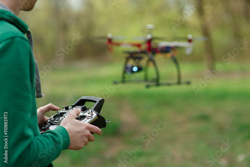 Man controling a drone.