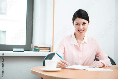 wonam work with papers in office room. © Sergey