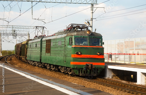 Railway freight train passes by at the turn