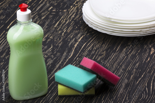 sponges, dishes and a bottle of detergent