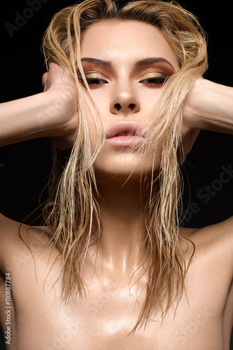 Beautiful girl with a wet hair and creative bright makeup