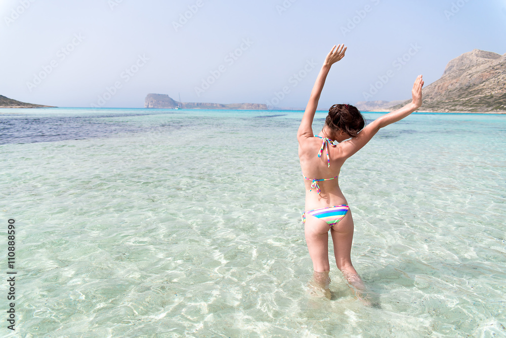 a happy girl enjoying blue sea