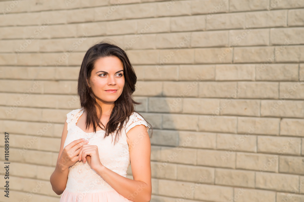 young woman brick wall young woman brick wall