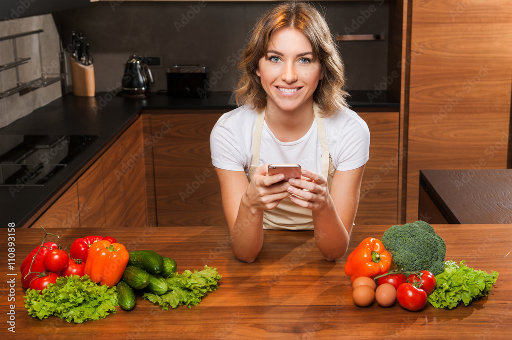 Young and beautiful housewife woman cooking in a kitchen Young and beautiful housewife woman cooking in a kitchen