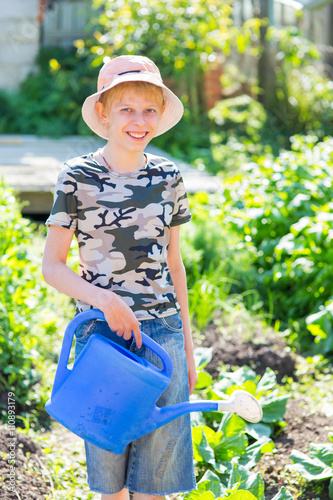 boy with a watering can