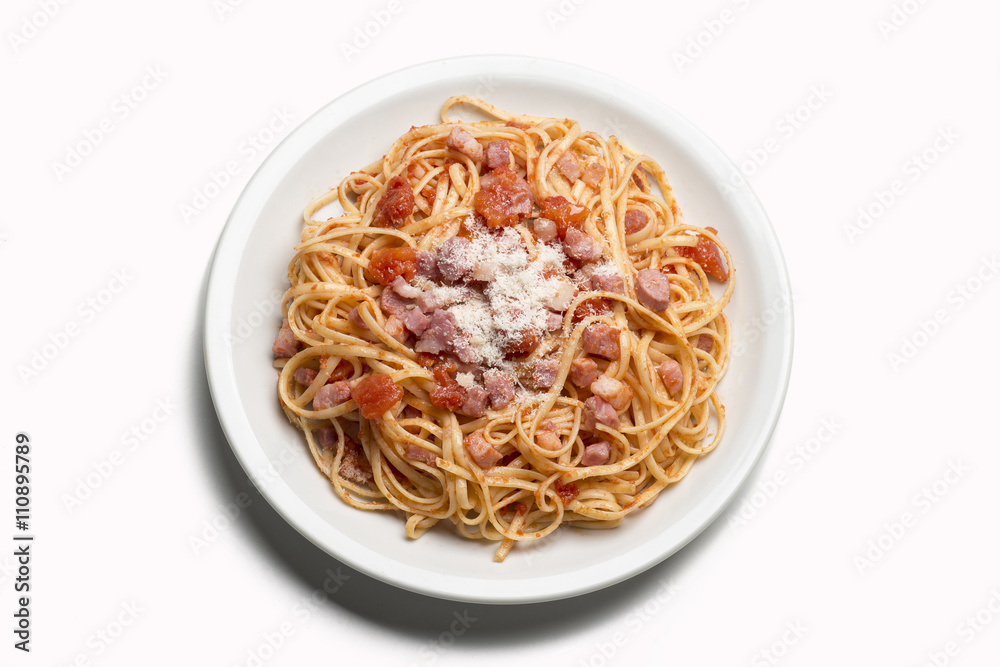spaghetti with amatriciana sauce in the dish on the wooden table
