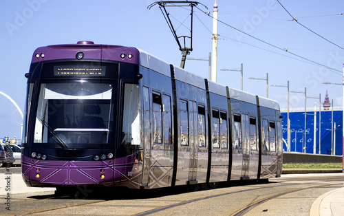 A bright streetcar traverses Blackpool City Street