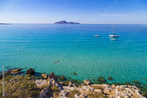Azure lagoon called Cala Rossa with yachts moored on Favignana island in Sicily, Italy