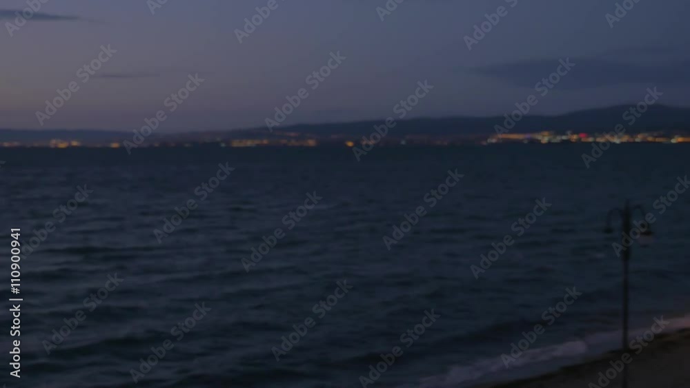 Steadicam shot of young couple looking at quiet sea from hotel balcony at night. They holding hands and man embracing woman. Romantic vacation Steadicam shot of young couple looking at quiet sea from hotel balcony at night. They holding hands and man embracing woman. Romantic vacation