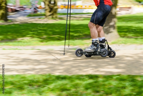 Man cross country skiing with roller ski photo