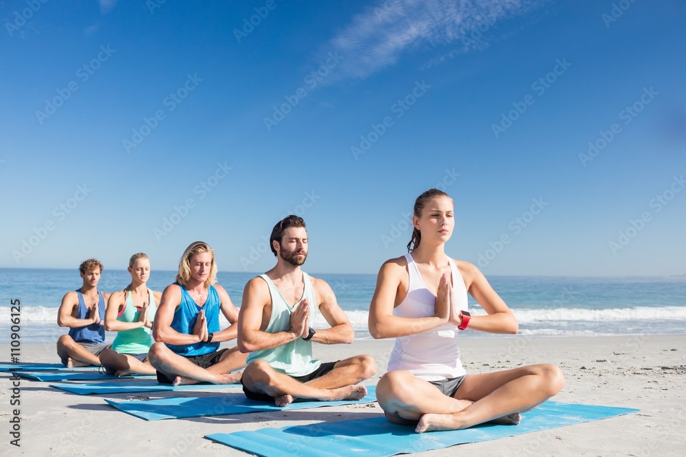 People doing yoga on the beach People doing yoga on the beach