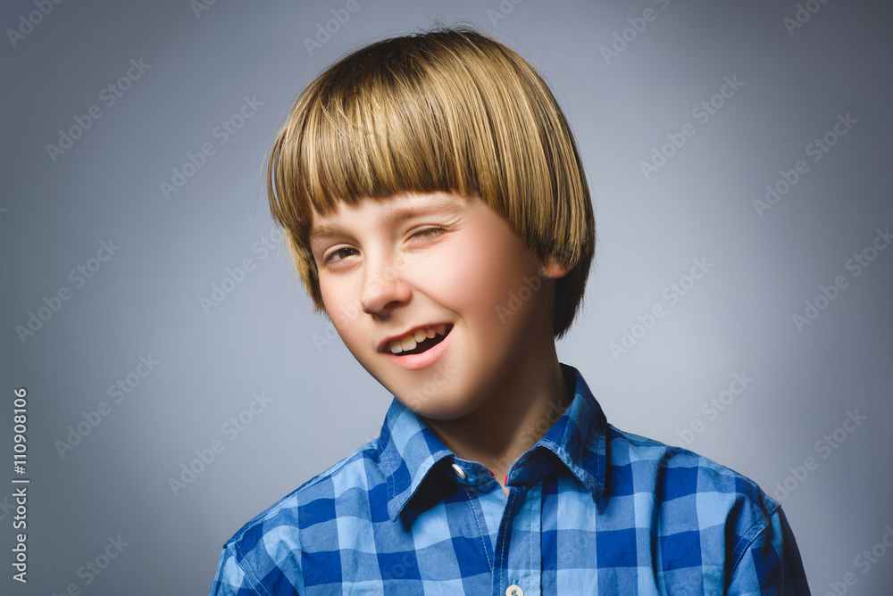 Closeup Portrait of handsome boy, over a gray background Closeup Portrait of handsome boy, over a gray background