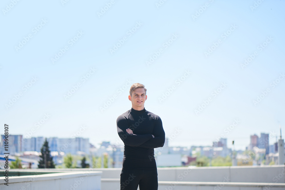 Portrait of a male athlete on the background of the city Portrait of a male athlete on the background of the city