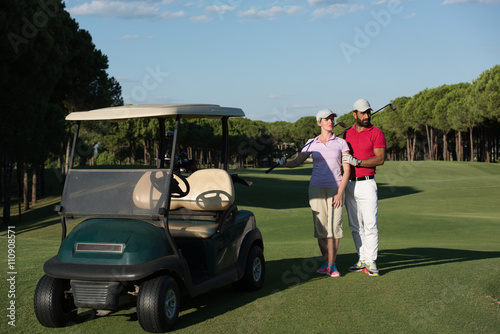 couple in buggy on golf course