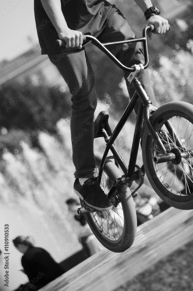 Bmx rider. Vertical picture. Extreme sport concept. Man riding by bicycle.  Photos | Adobe Stock