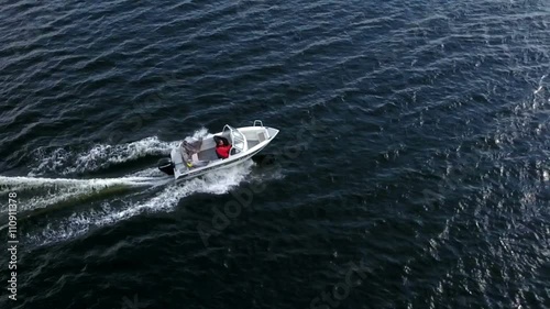 Wallpaper Mural Small powerboat riding on water surface, slow motion aerial view from drone
 Torontodigital.ca