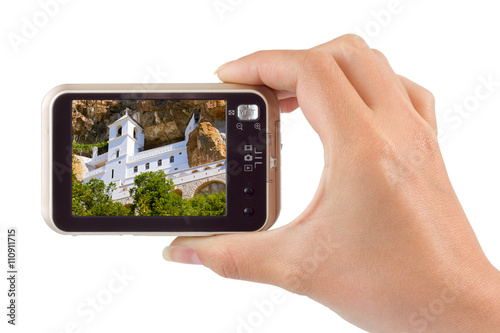 Hand with camera and Ostrog monastery - Montenegro image (my pho