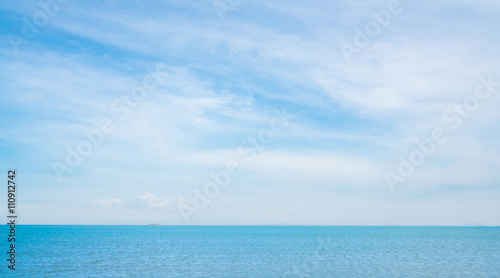 Blue sea on sunny, cloudy sky background