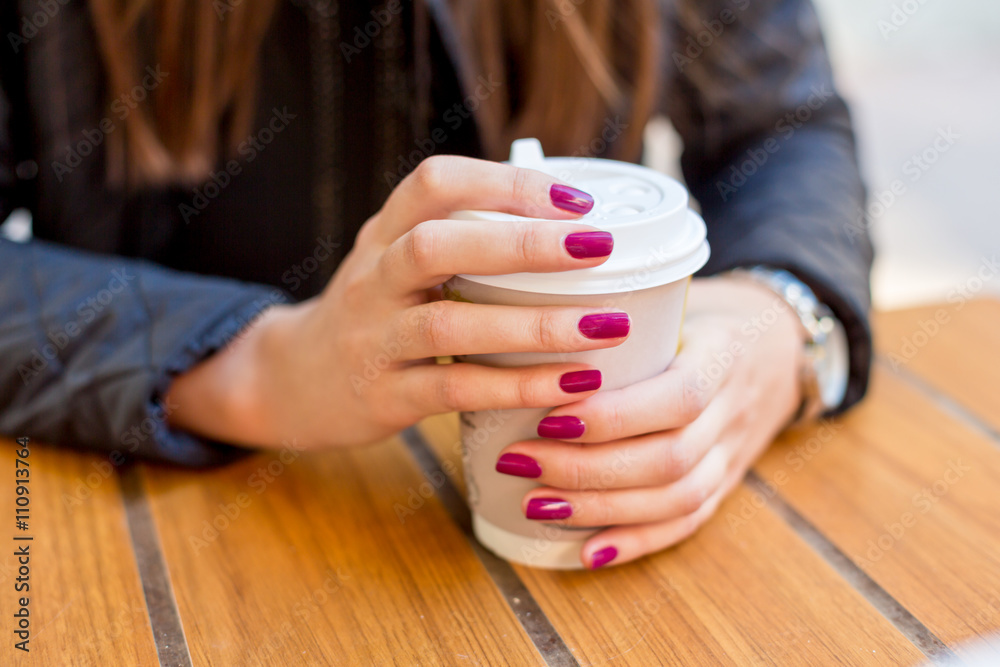 woman in brown color white wall and coffee on table woman in brown color white wall and coffee on table