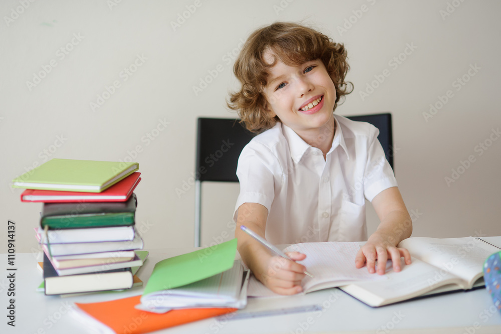 Schoolboy in the classroom writing something Schoolboy in the classroom writing something