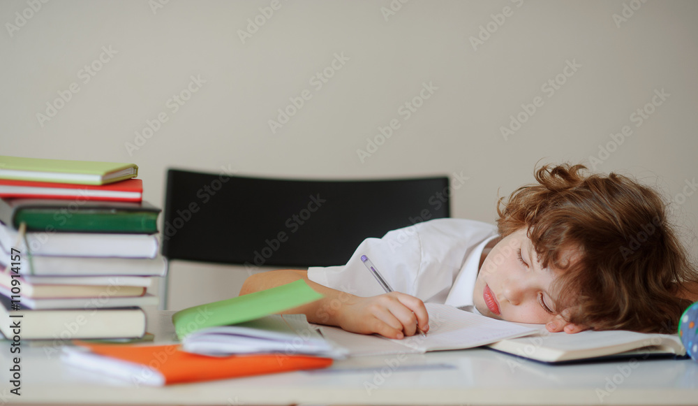 Boy fell asleep while sitting at a desk Boy fell asleep while sitting at a desk