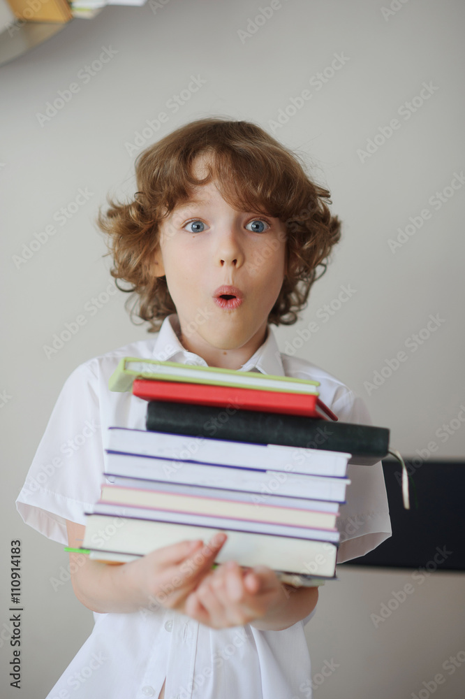 Schoolboy holding a stack of books. Schoolboy holding a stack of books.