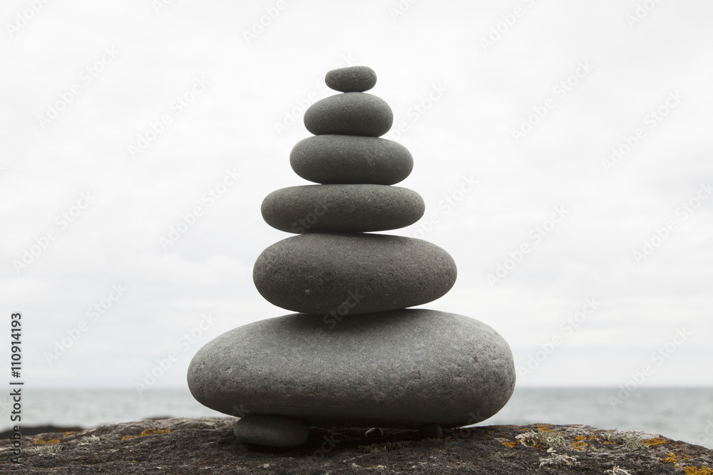 Six coastal stones balanced on top of each other Six coastal stones balanced on top of each other