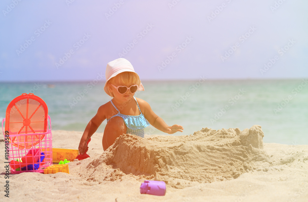 little girl play with sand and toys on beach little girl play with sand and toys on beach