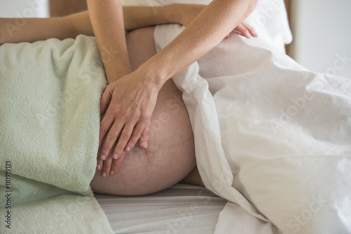 Woman having prenatal massage photo