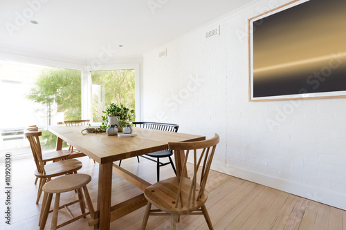 Scandinavian styled dining room interior with contemporary artwo