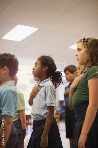 Children reciting Pledge of Allegiance in school photo