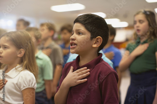 Children reciting Pledge of Allegiance in school photo