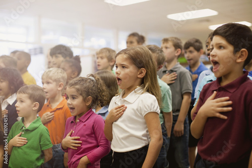 Children reciting Pledge of Allegiance in school photo