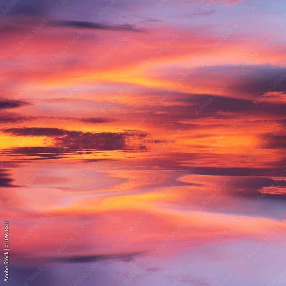 Orange and purple sunset reflected in water