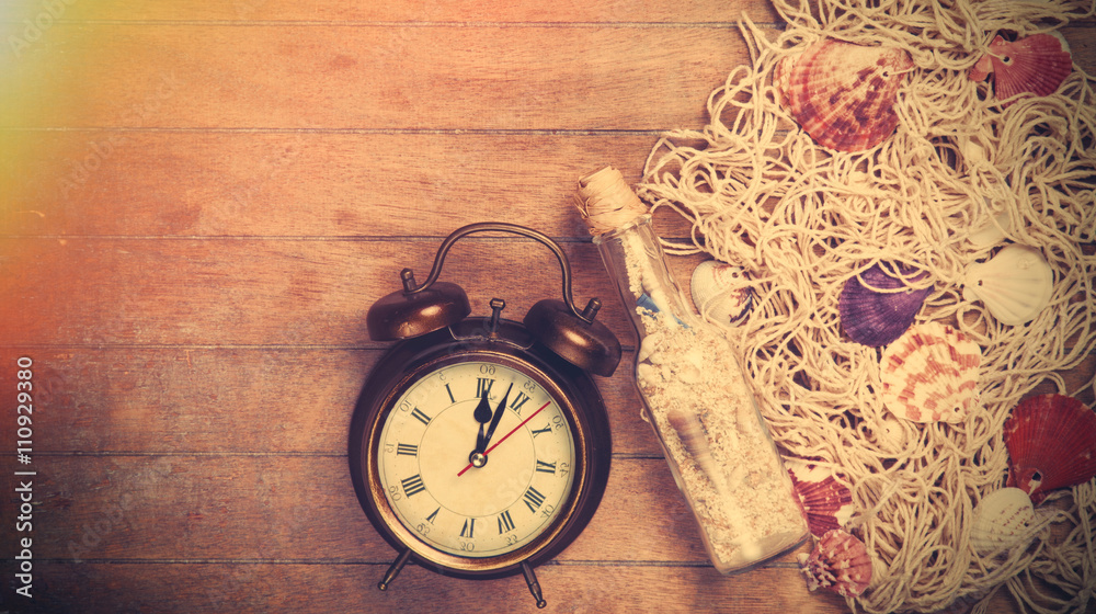 Retro alarm clock and net with shells and bottle Retro alarm clock and net with shells and bottle