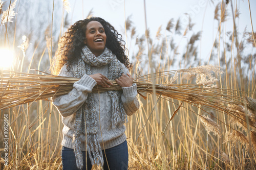 Woman carrying bundle of wheat