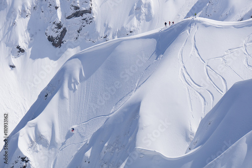 фотографія Snowboard freeride, snowboarders and tracks on a mountain slope