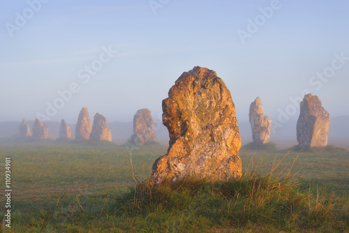Menhir alignment view at Camaret sur mer at sunrise during fog