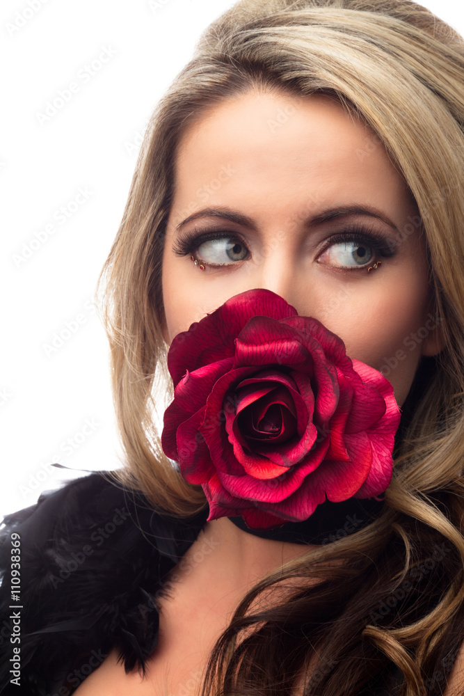 woman holding rose in mouth with sideway glance. woman holding rose in mouth with sideway glance.