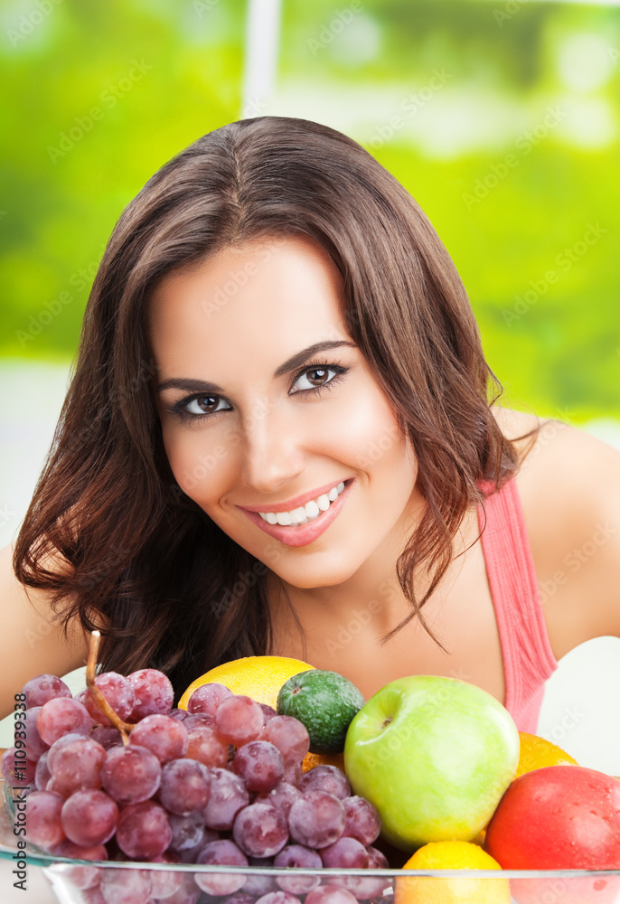 Woman with plate of fruits, outdoors Woman with plate of fruits, outdoors