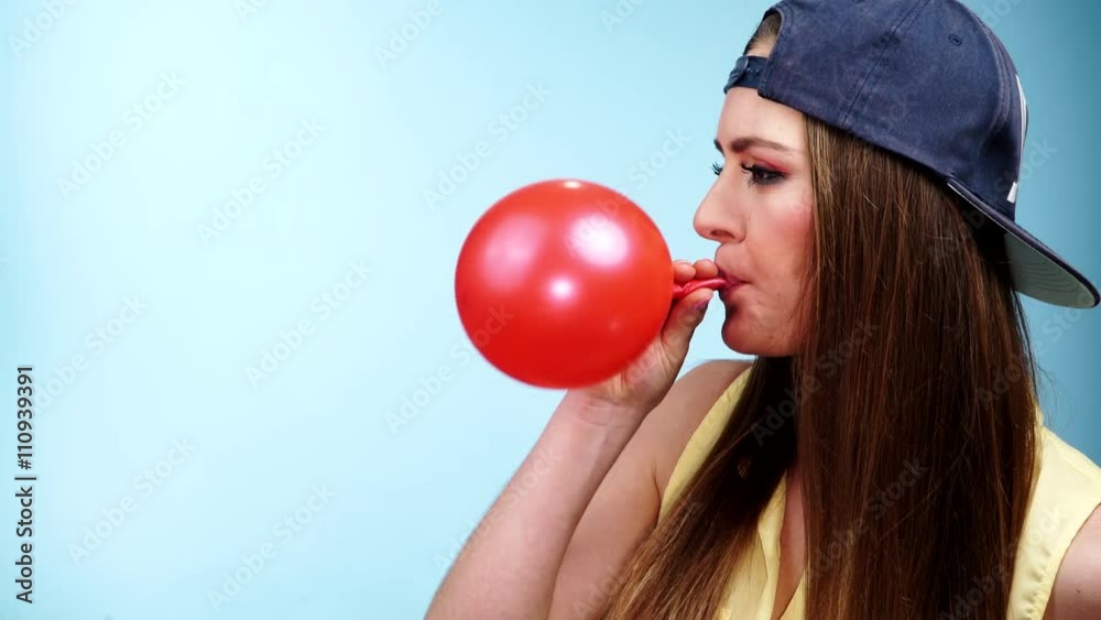 Woman casual style blowing up a red balloon 4K