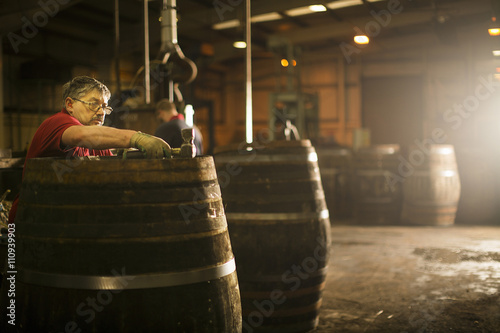 Mature man making whisky cask in cooperage