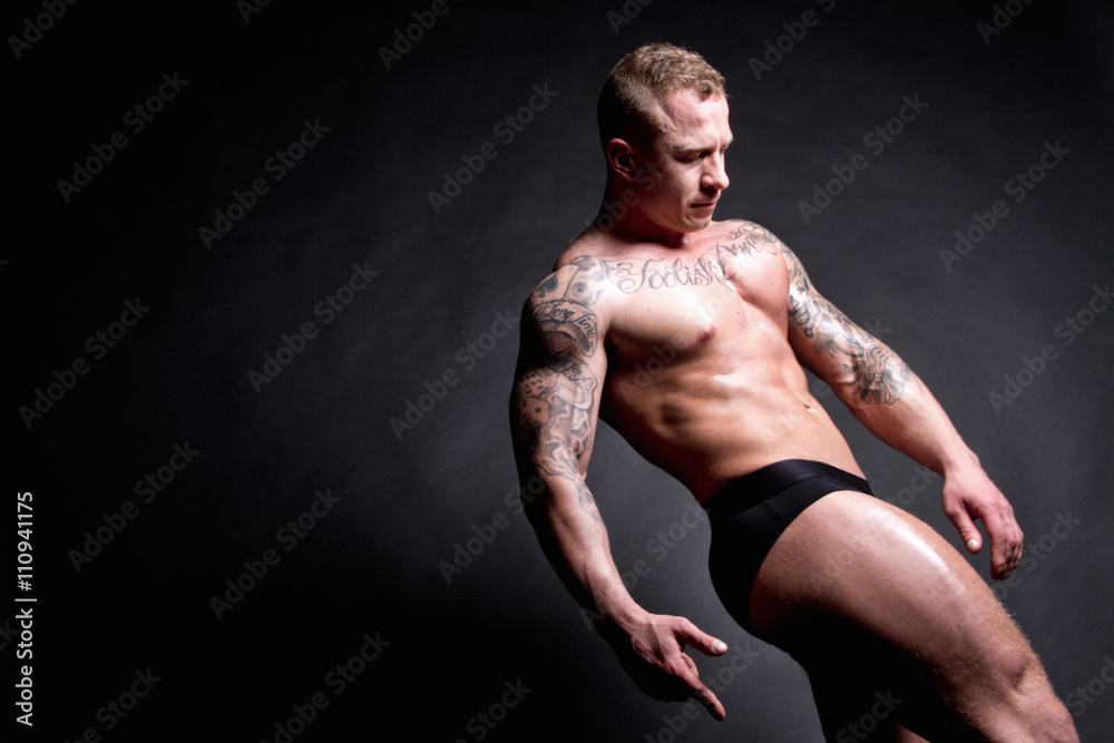 Muscular young man leaning back Muscular young man leaning back