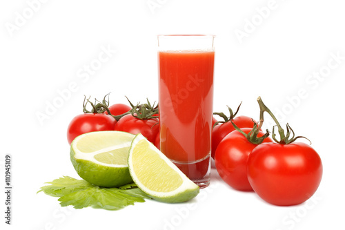 Tomato juice, lime and bunch of tomatoes over white.
