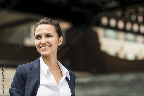 Young businesswoman outside station with digital tablet, London, UK photo