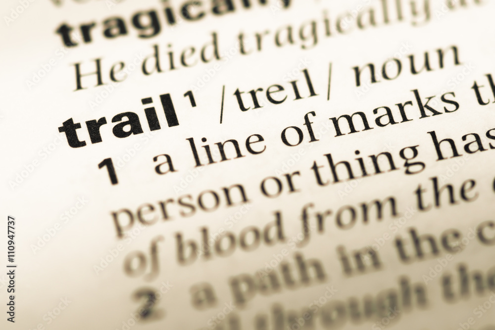 Close up of old English dictionary page with word trail Close up of old English dictionary page with word trail