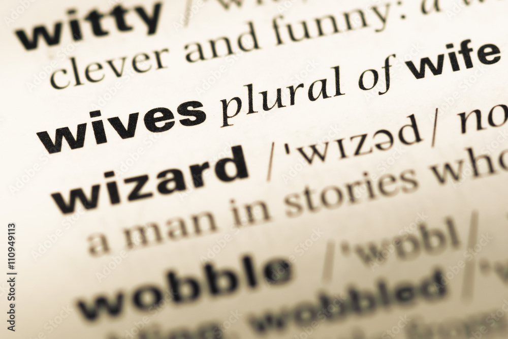 Close up of old English dictionary page with word wives Close up of old English dictionary page with word wives