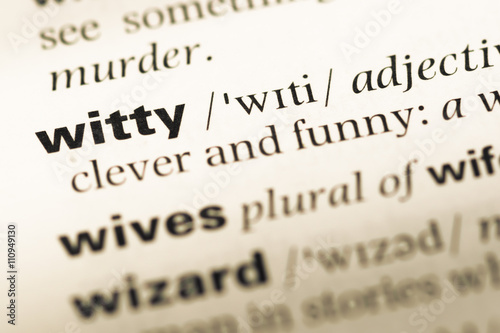 Close up of old English dictionary page with word witty