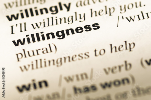 Close up of old English dictionary page with word willingness